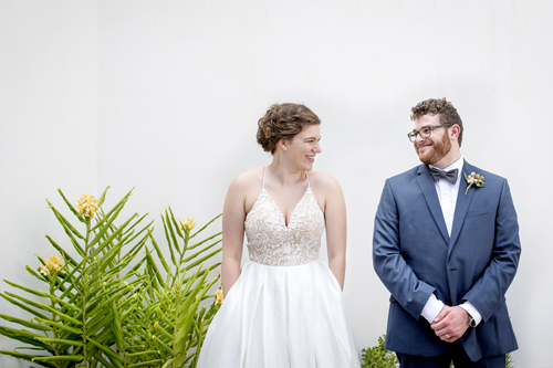 happy bride and groom waiting outside