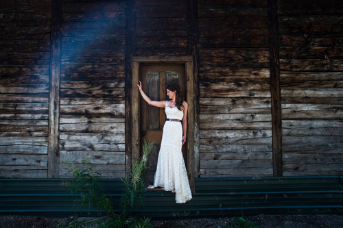 bride standing against wooden backdrop