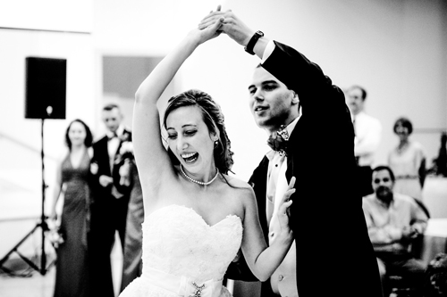 black and white photo of bride and groom dancing at wedding