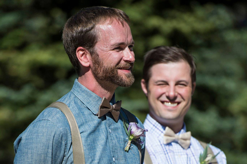 groom smiling at the sight of bride