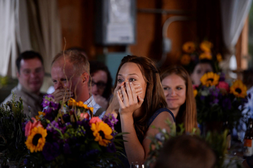 woman covering mouth in surprise at wedding